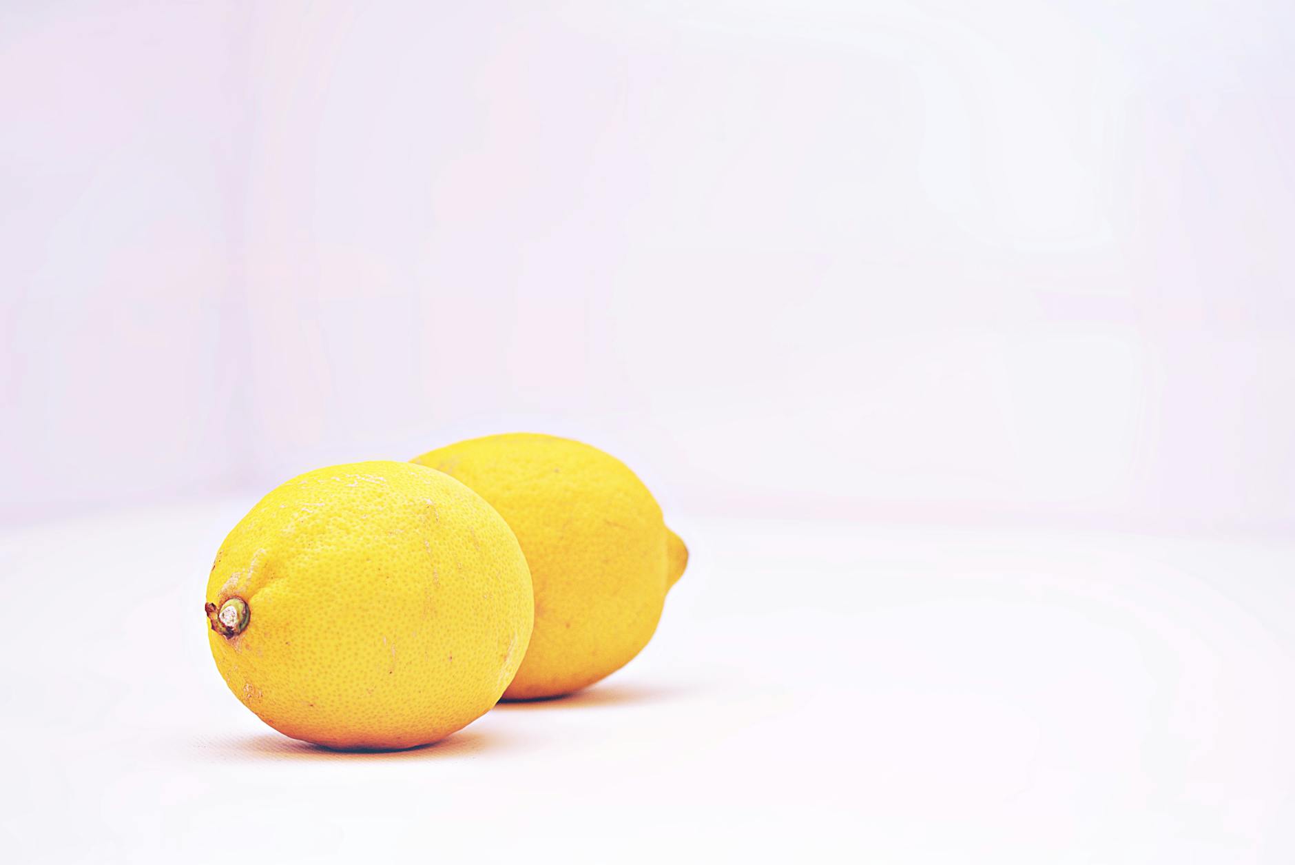 Two fresh lemons against a white background, symbolizing renewal and reset