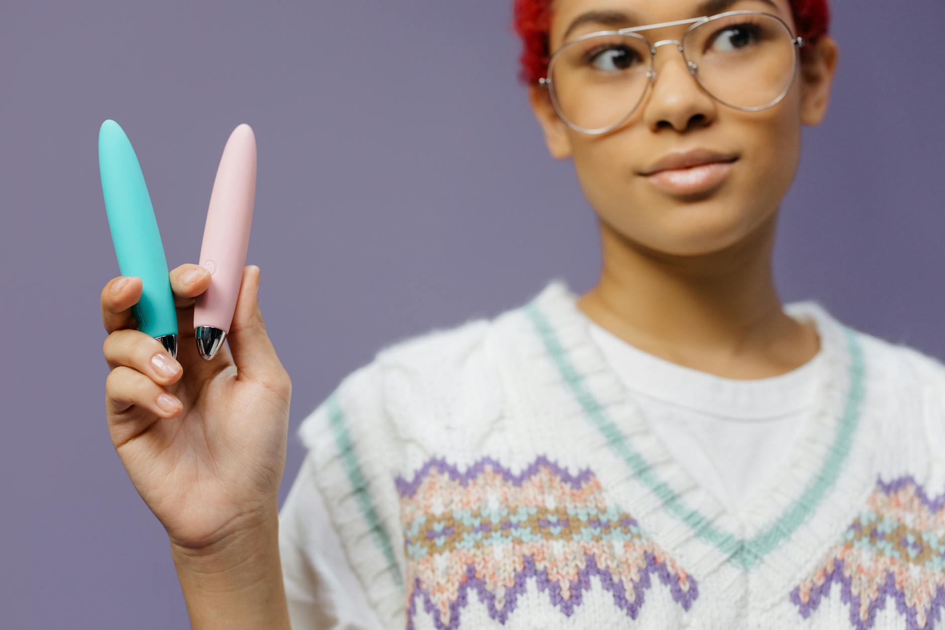 Colorful clitoral vibrators displayed against a vibrant purple background