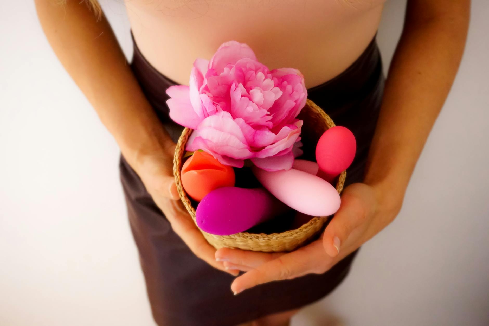 A vibrant collection of lemon-colored vibrators and pleasure devices in a woven basket