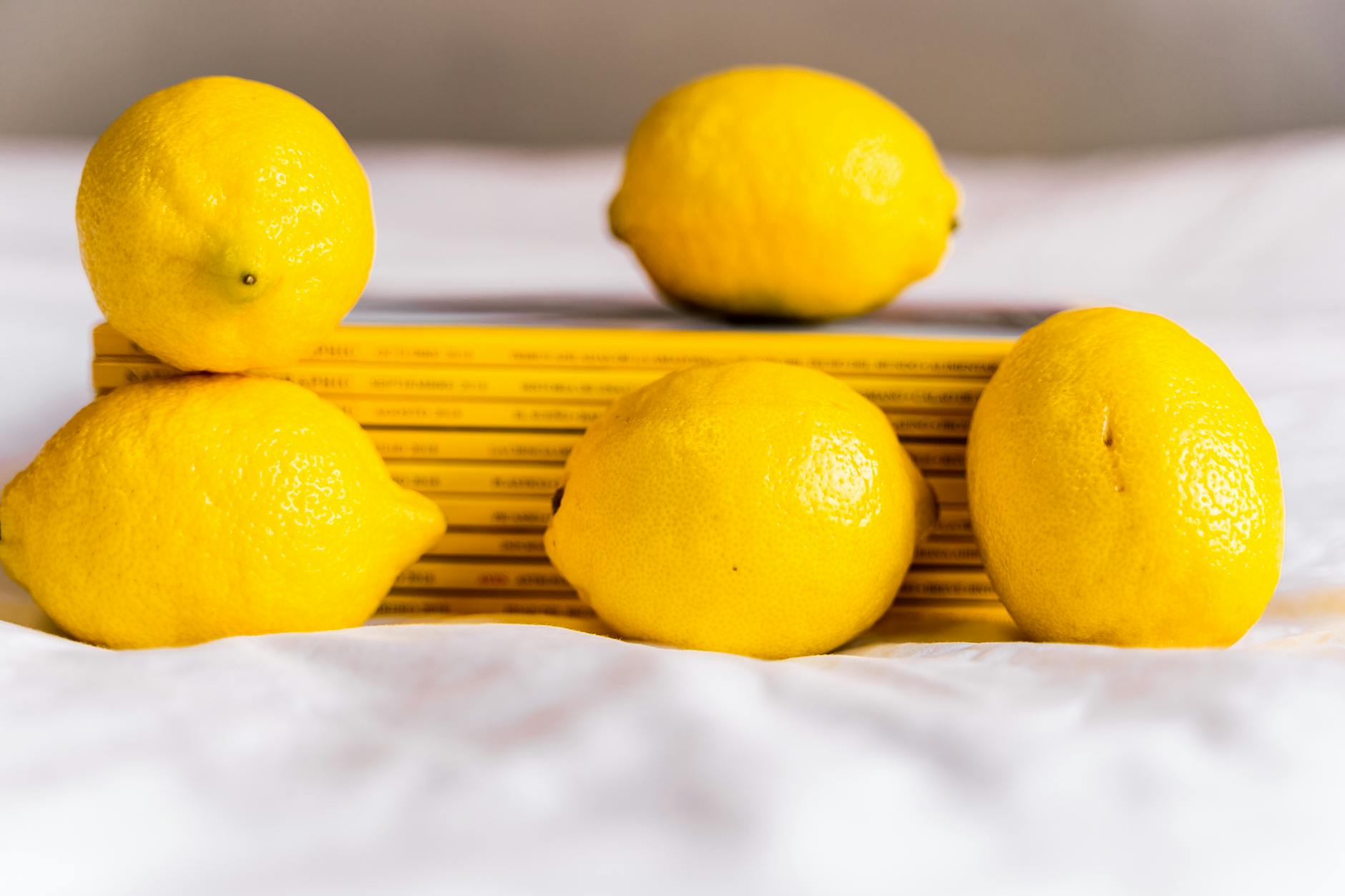 Fresh lemons stacked with books, symbolizing the freshness of starting a new chapter with birth control